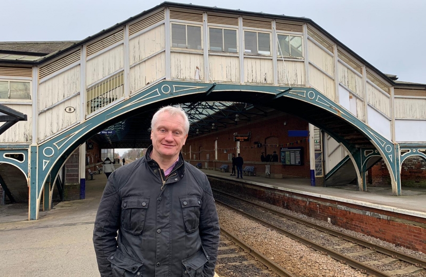 Graham stood in front of the bridge at Beverley train station