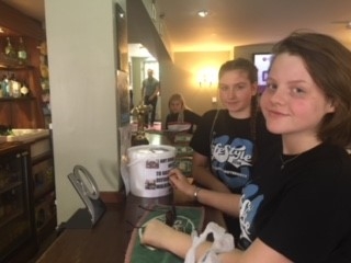 Jess and Amelia raising money for the Walkington defibrillator with charity collection buckets