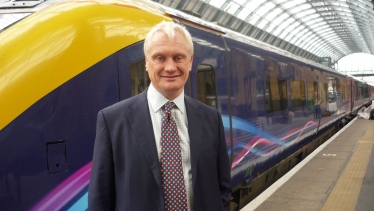 Graham standing in front of a train in Beverley Train Station.