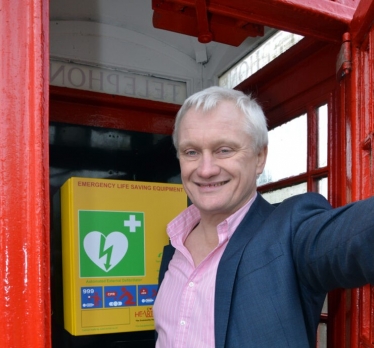 Graham inside a red telephone box housing a CPAD