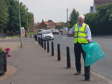 Graham litter picking in the Samman road play area.