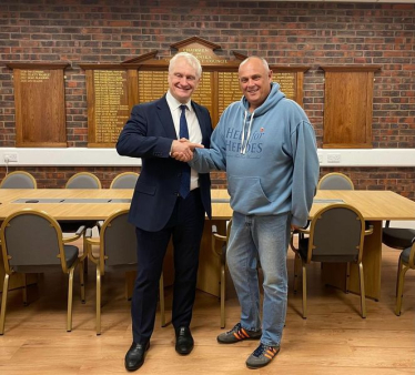 Darren England and Graham Stuart MP shaking hands