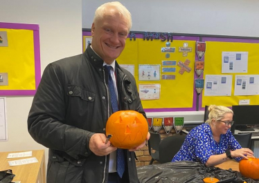 Photo of Graham Stuart carving a pumpkin at Withernsea High School